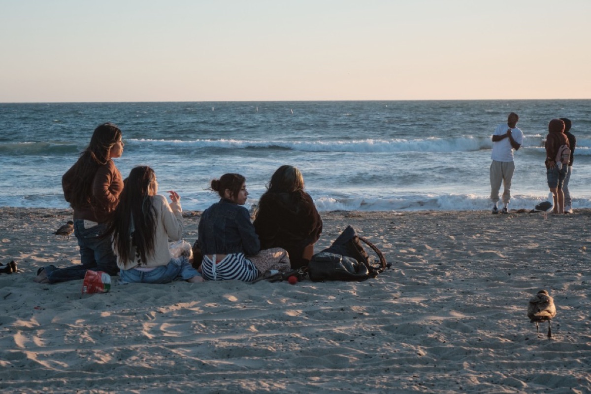 Friends sitting together at the beach